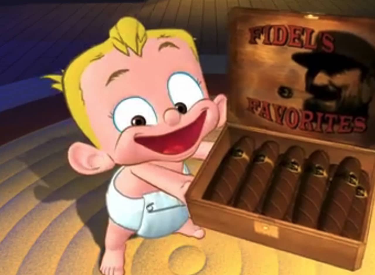 baby holding up an open box of Cuban cigars