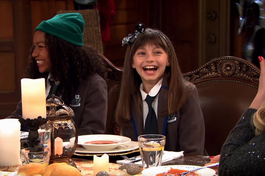 Sasha and friend laughing at the dinner table