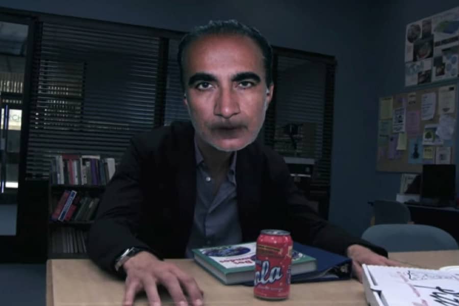 Abed’s father’s head superimposed over Jeff Winger’s body in the study room
