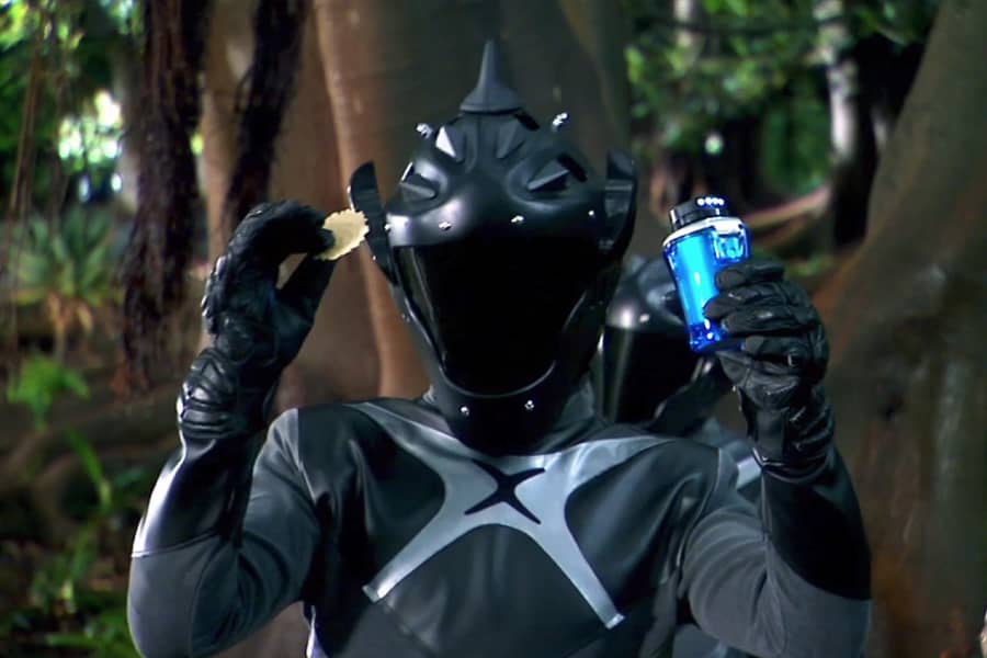 a Dorlock holding up a cracker and a bright blue beverage
