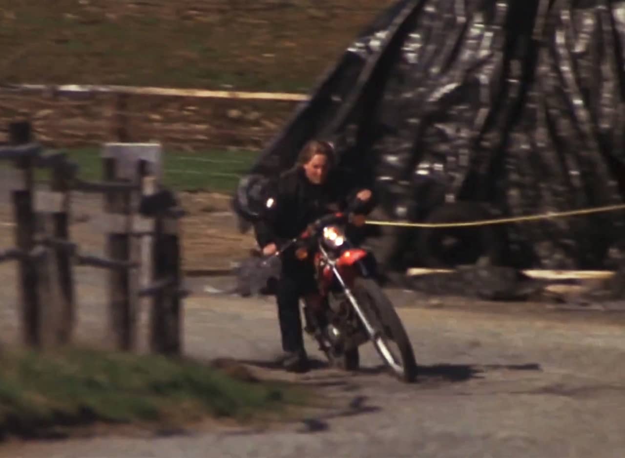 guy riding a motorcycle on a dirt road