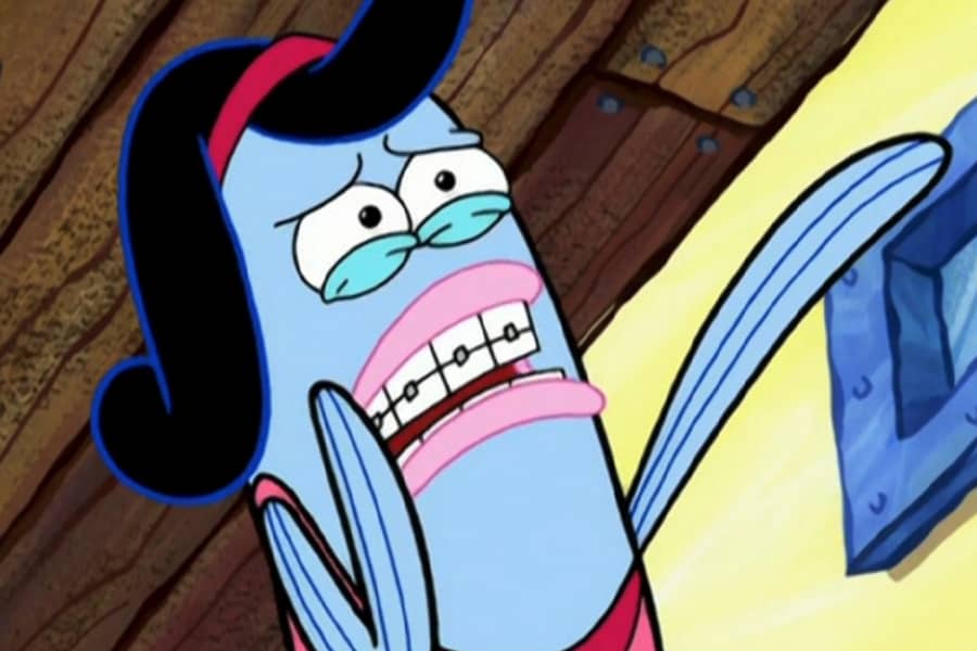 scared teen girl with braces pointing