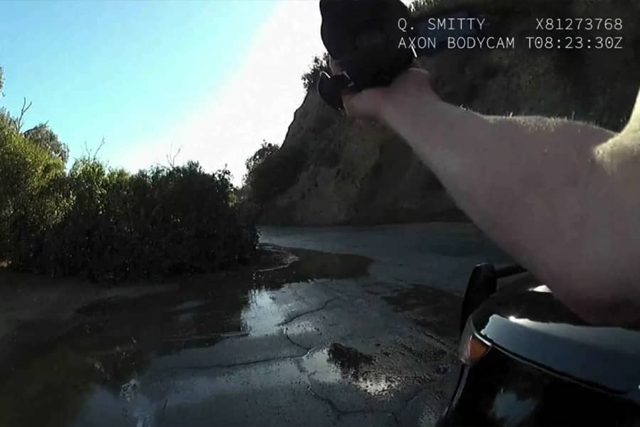 Smitty filming along a quiet road