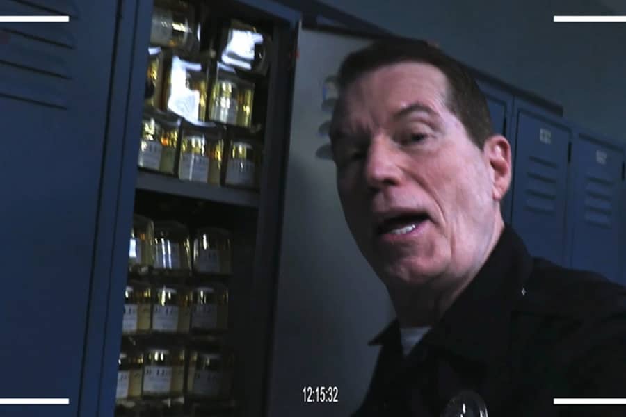 Smitty next to an open locker full of cosmetic product
