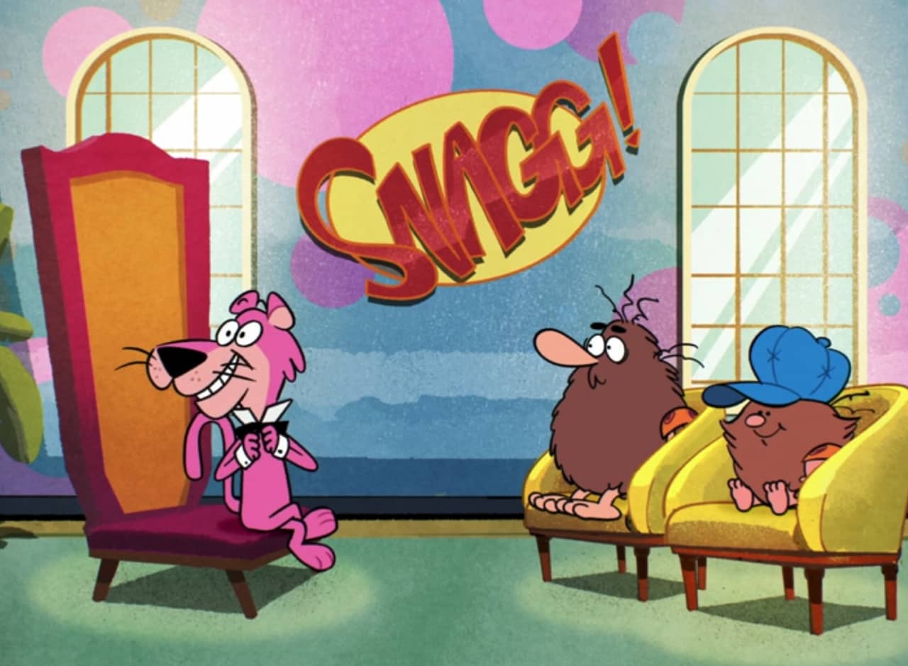 a talk show set with host Snagglepuss and guests Captain Caveman and Cavey Jr.