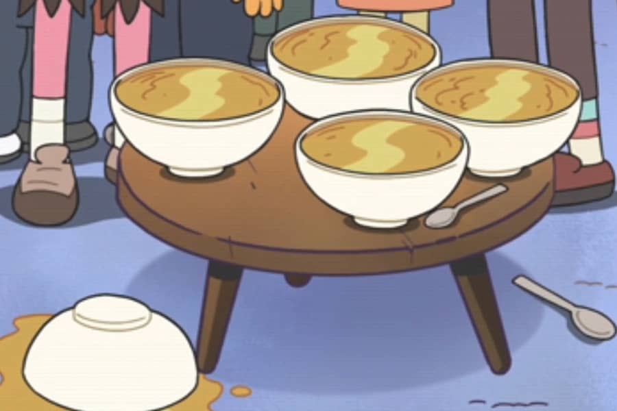 coffee table with four large bowls of soup, another bowl is spilled on the floor