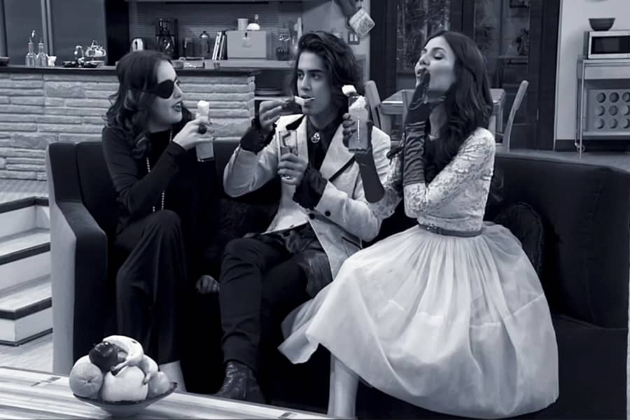 Mrs. Bowman, a woman with an eyepatch, with two guests drinking cocktails