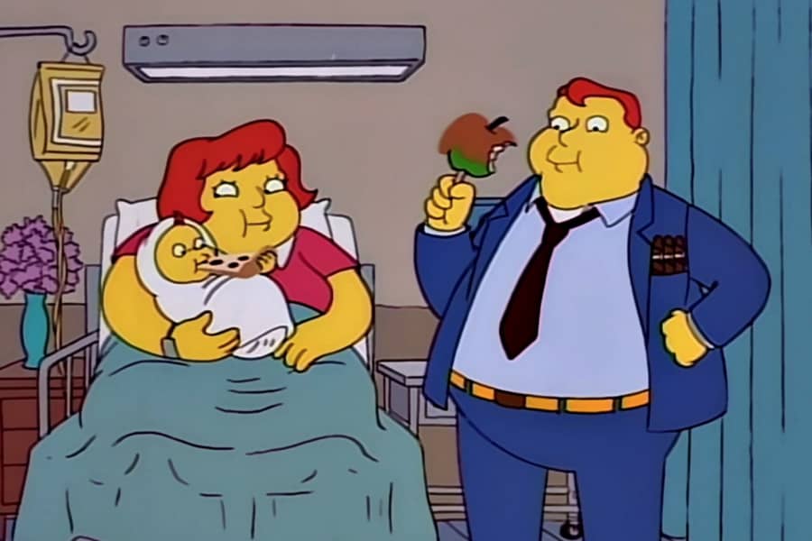 fat woman with a new baby in the hospital, her husband is eating a caramel apple and the baby is eating some pizza