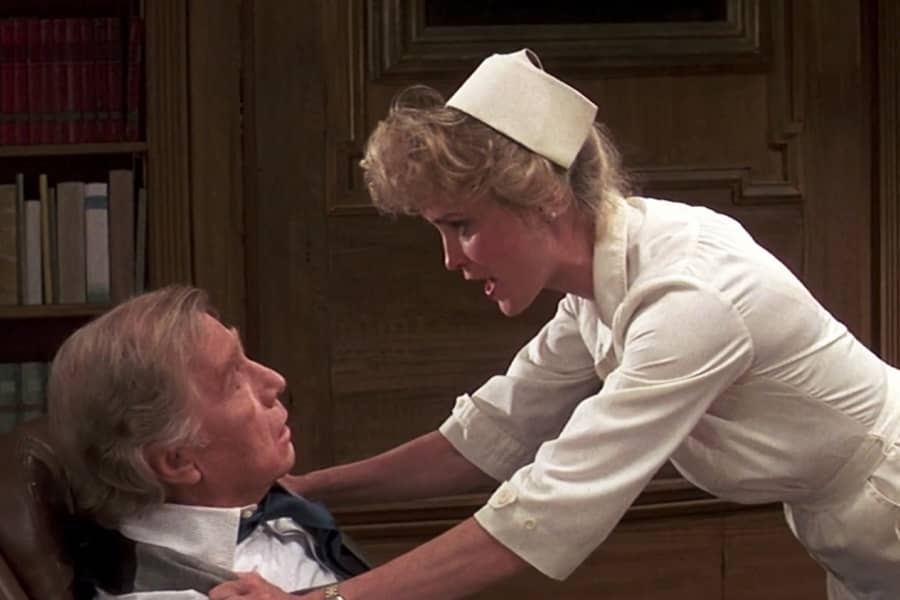 the young nurse speaks passionately with her arms gripping the male doctor’s arms