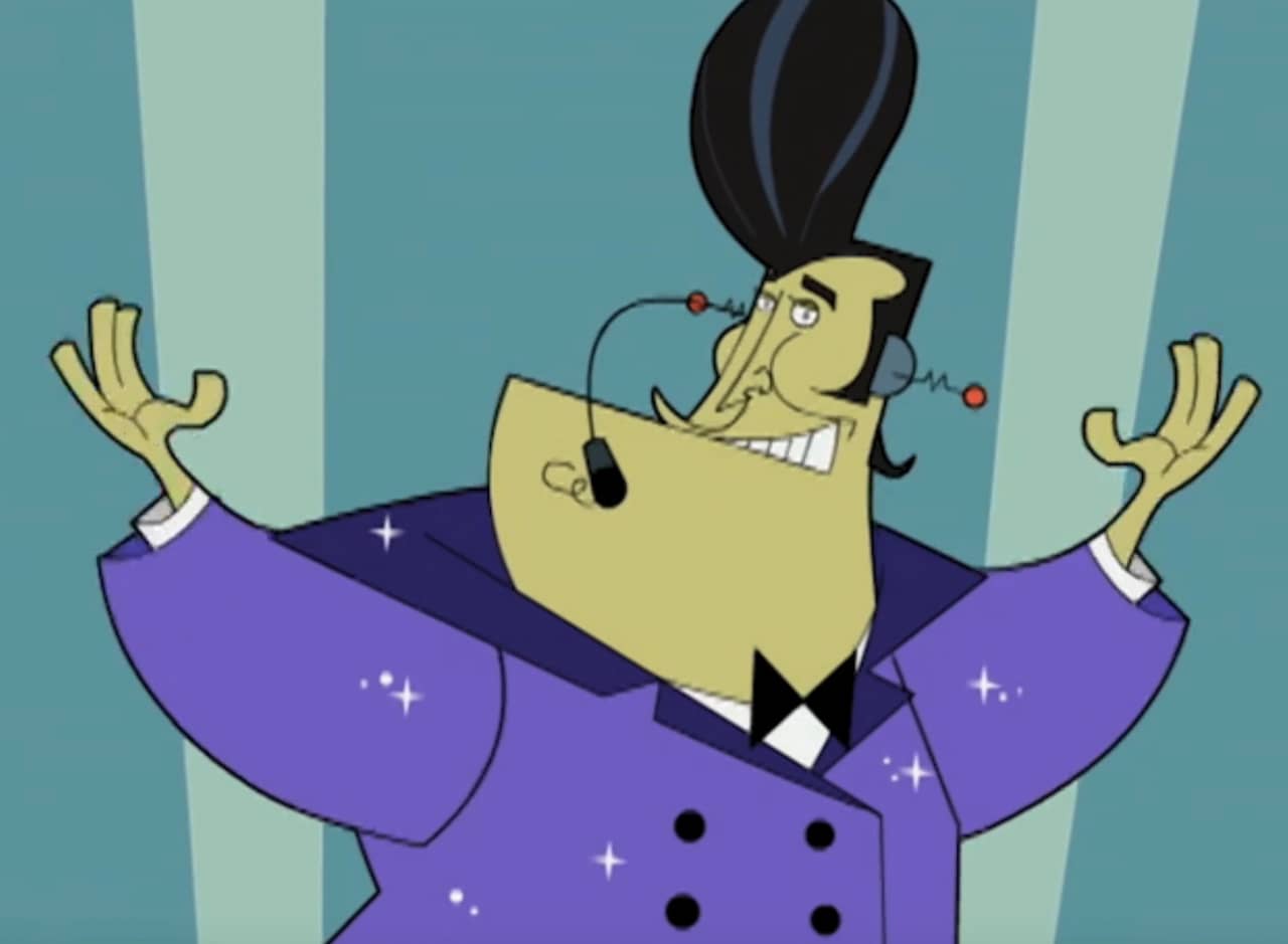 host Captain Chuck, a man in a purple suit and with big poofy black hair