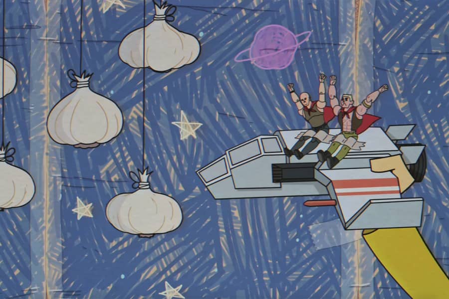 toy spaceship with two action figures taped to it approaching a space field of garlic bulbs