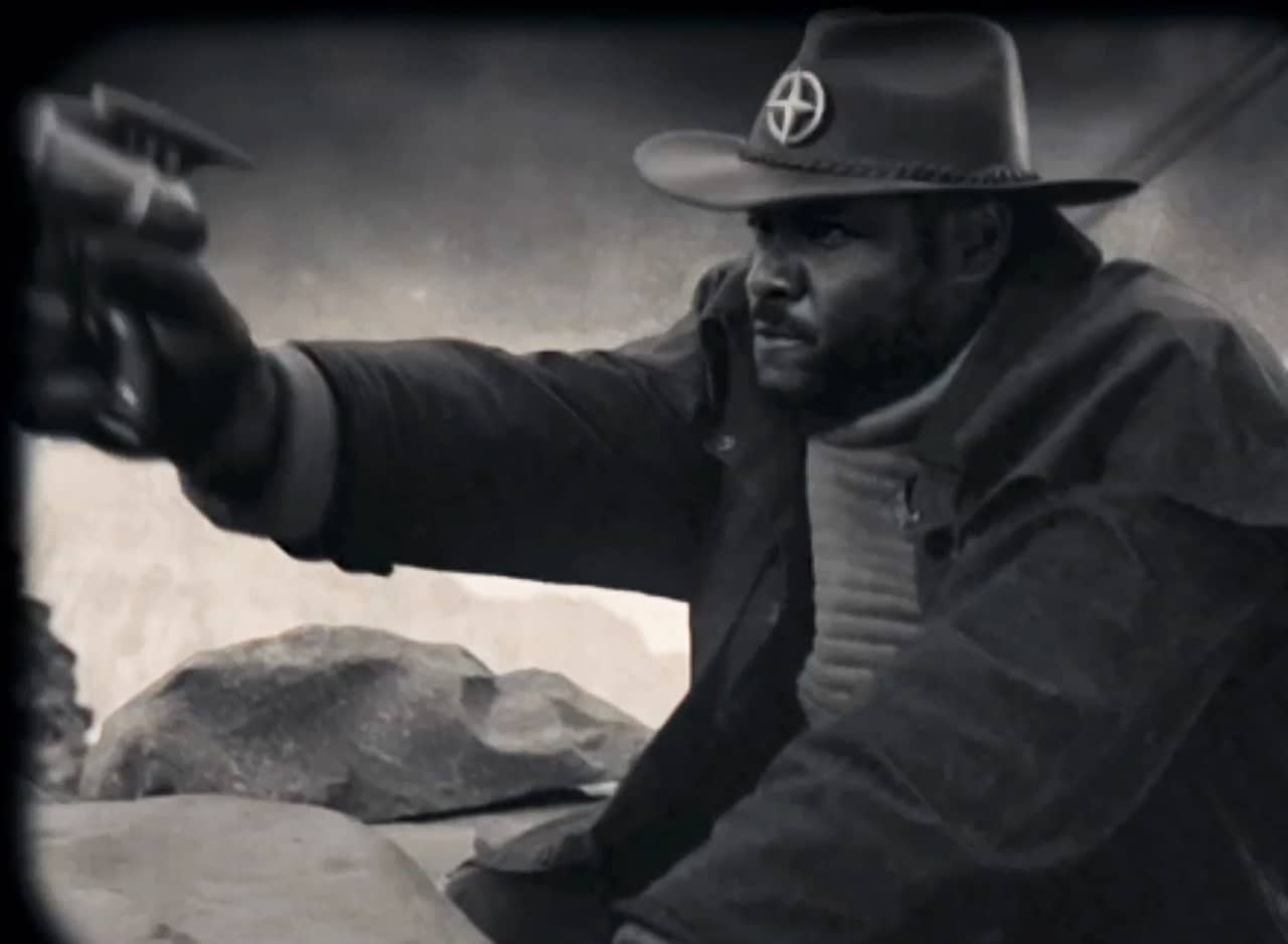 Buck Manzell as the Space Sheriff, in Western garb, pointing a laser gun
