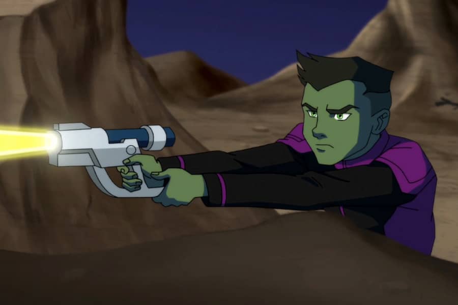 Tork shoots a laser gun from behind a rock