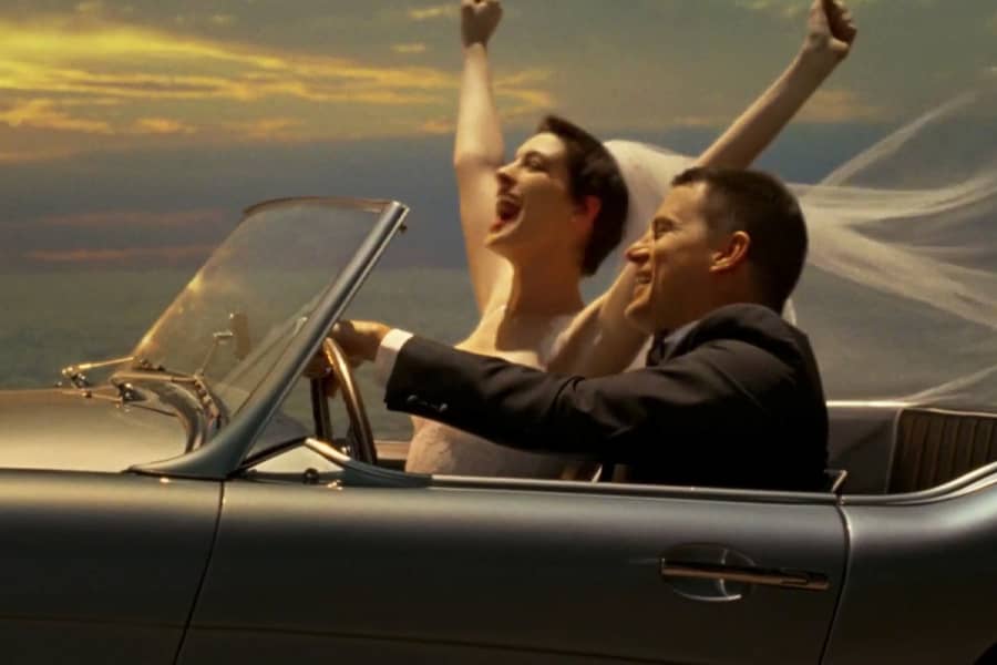 Verreaux and Lombardo freshly married, driving in a convertible