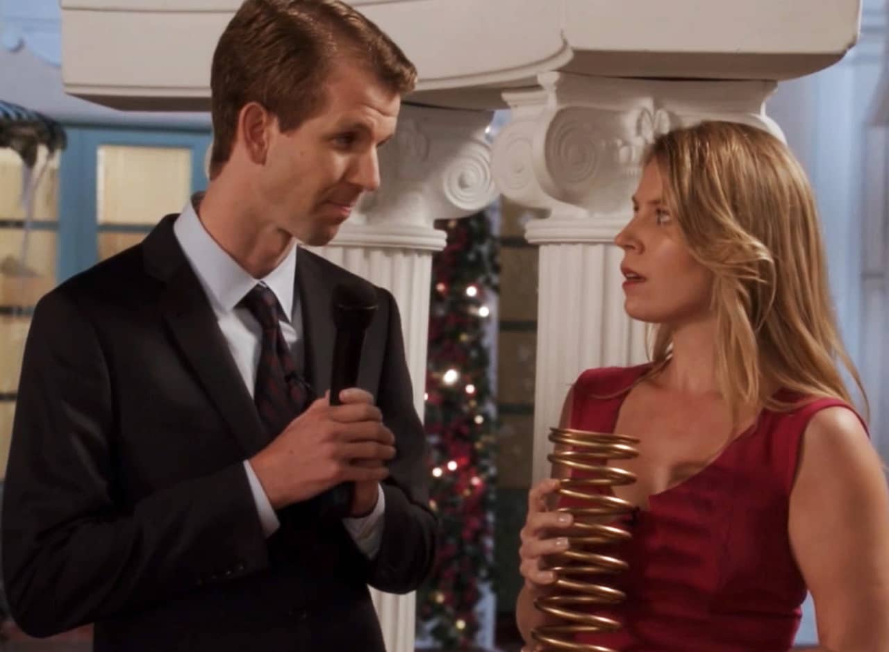 May with the host, she is holding a large golden spring