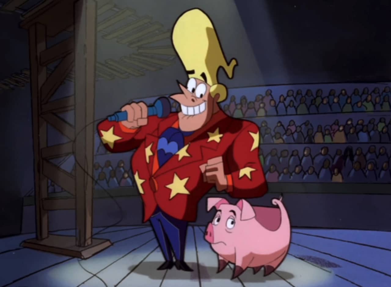 game show host with big blonde hair stands next to a pig