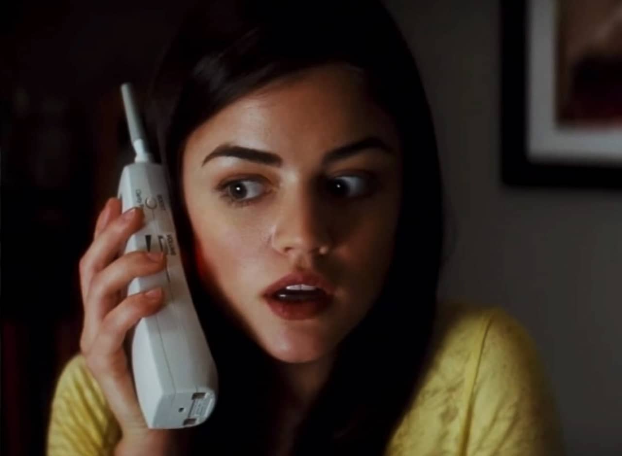 Lucy Hale talks on a cordless house phone