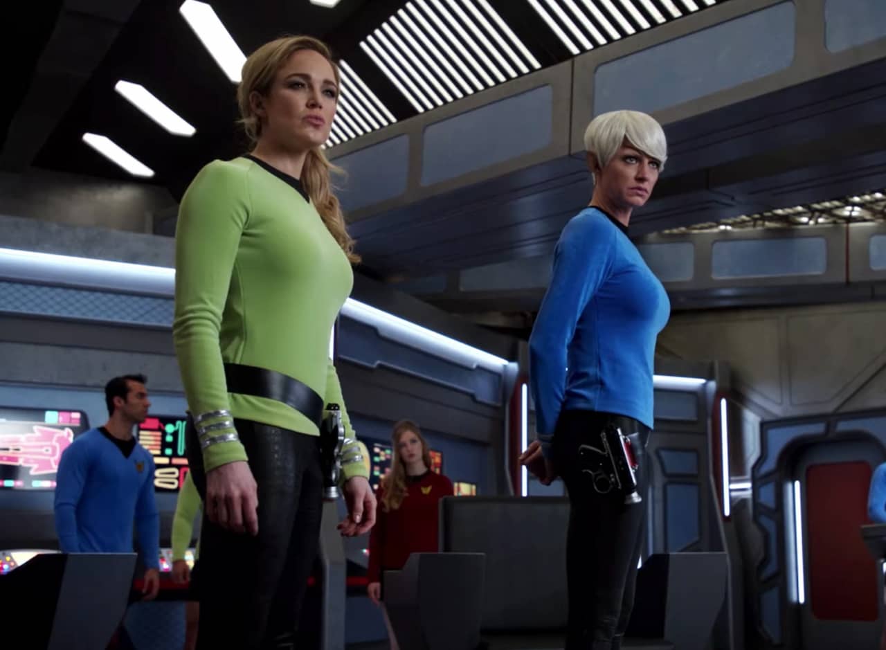 Captain Lance and Captain Ava in uniform on the bridge of the USS Faterider