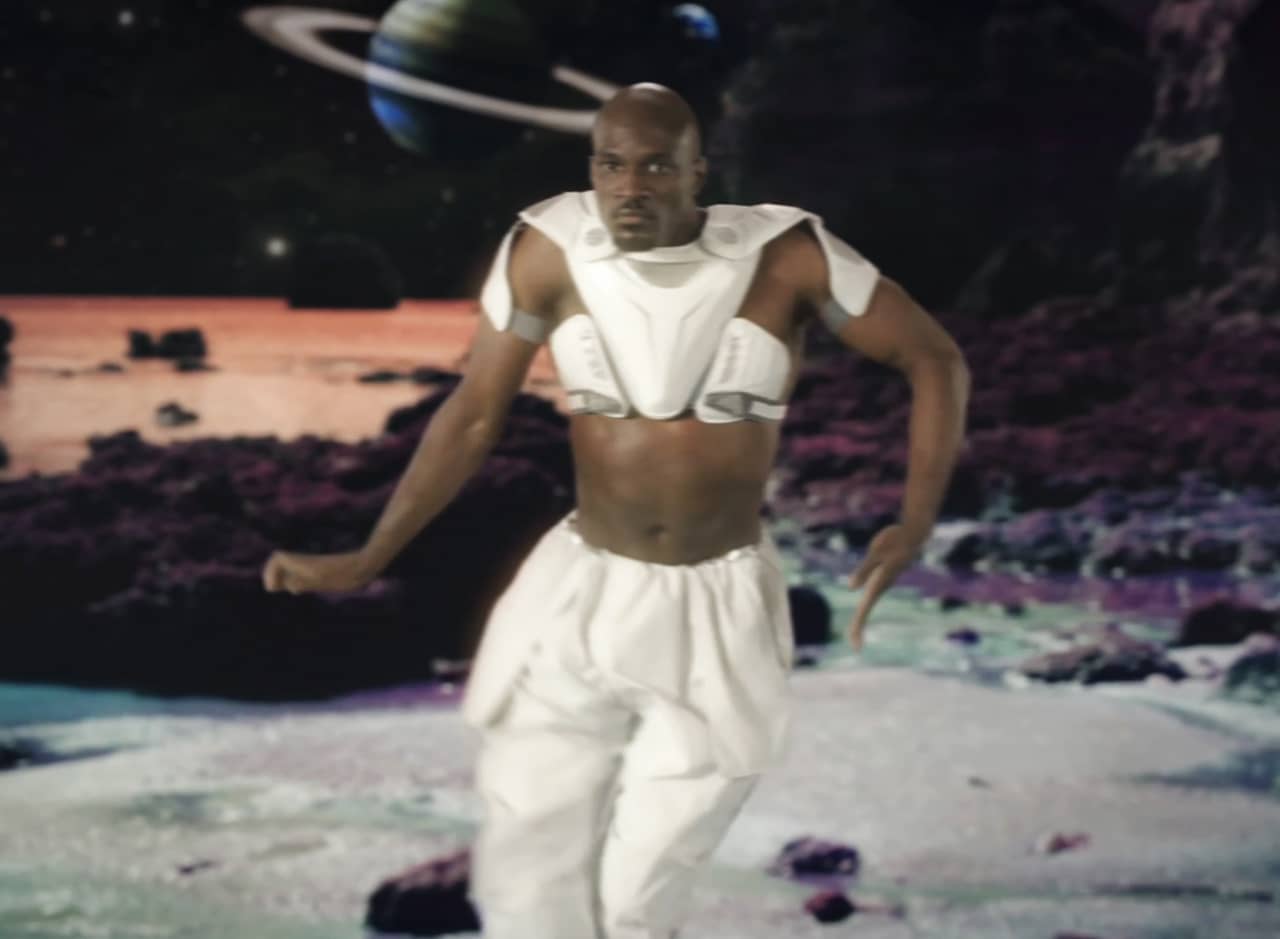 Torque in a futuristic midriff outfit dancing on another planet