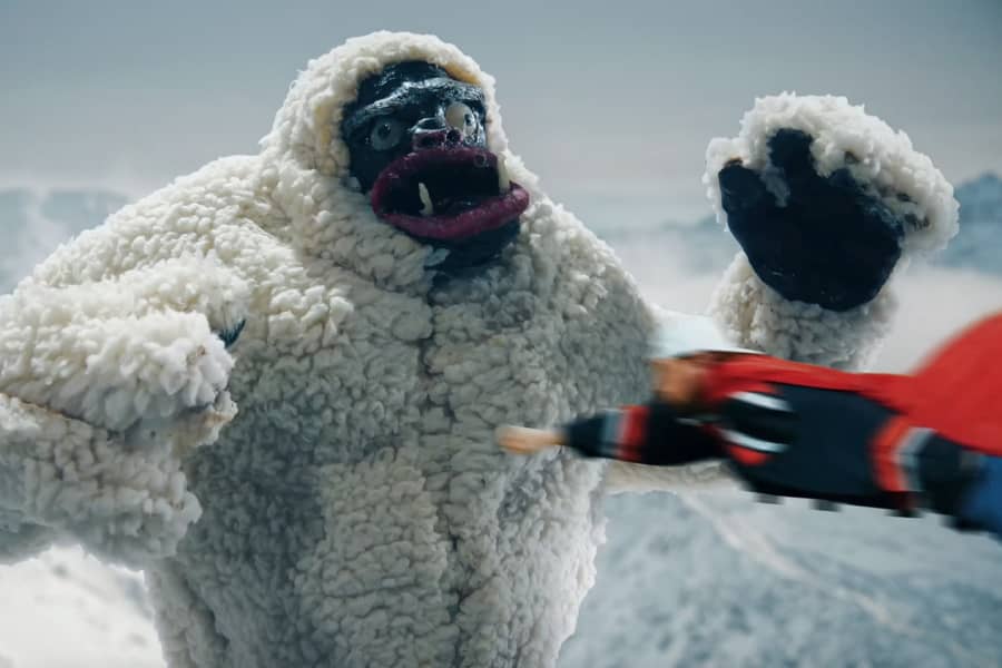 Super Mega Awesome Ultra Guy flies fast toward a mean yeti