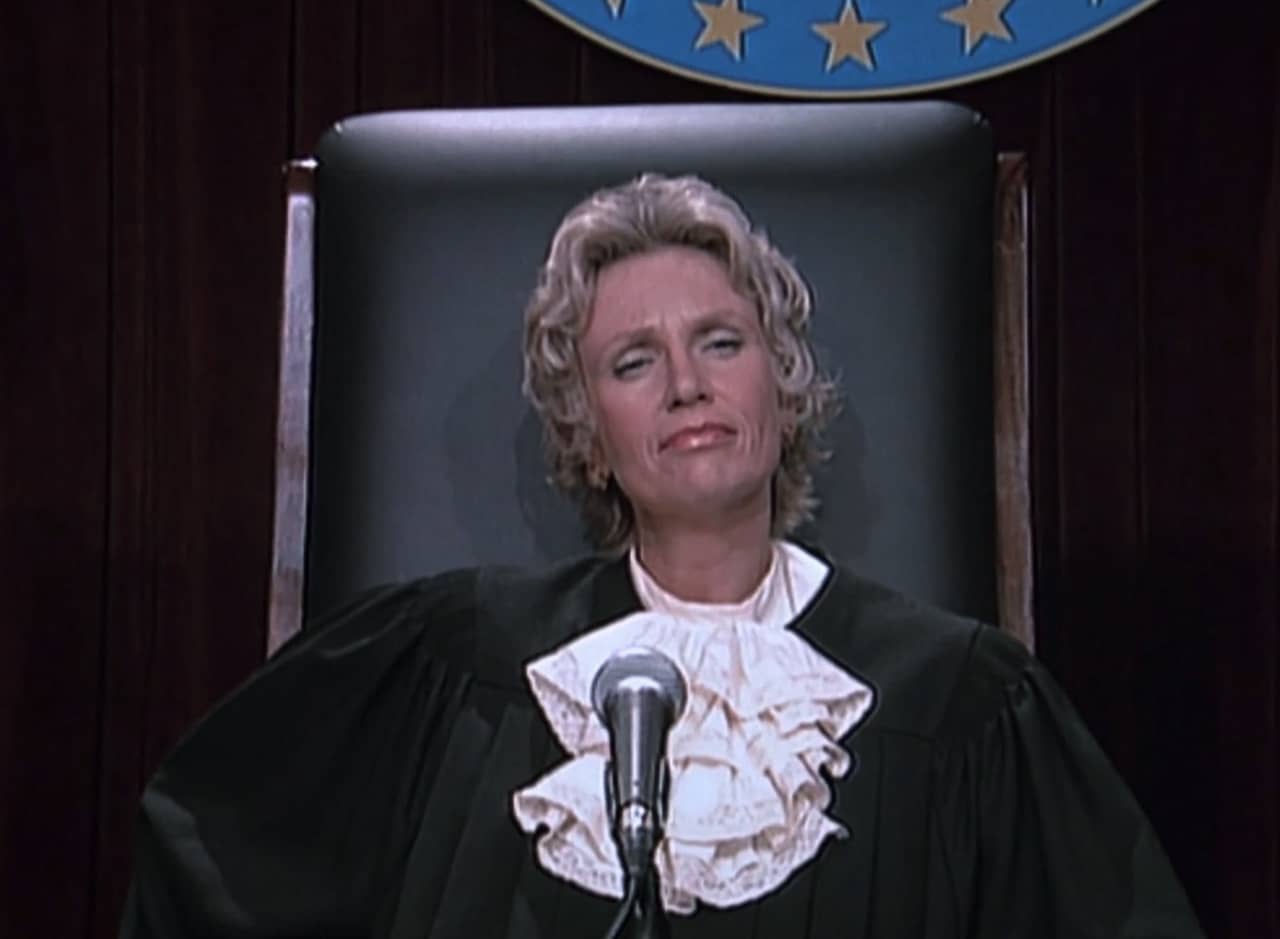 Laurie Bohner dressed as a judge on the stand
