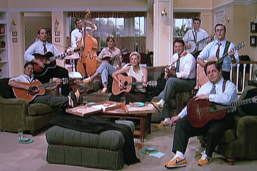 the band playing instruments in a living room