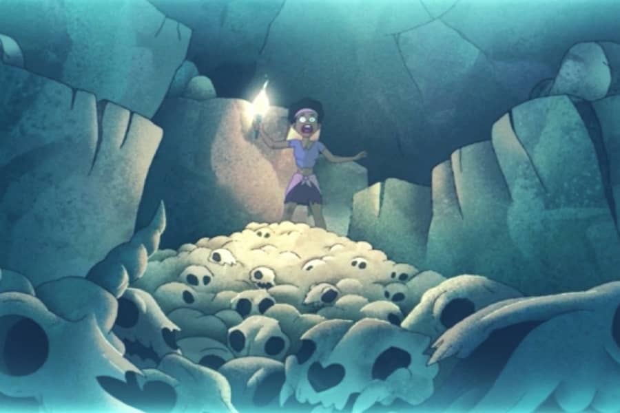 a woman holds a torch and screams as she sees the cave is full of animal skulls
