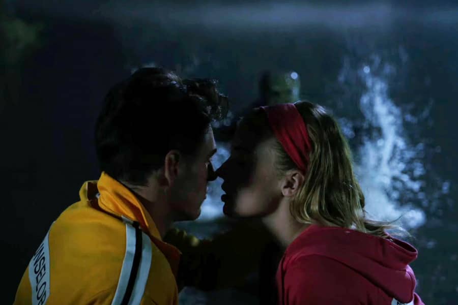 they are about to kiss but behind them, water is splashing