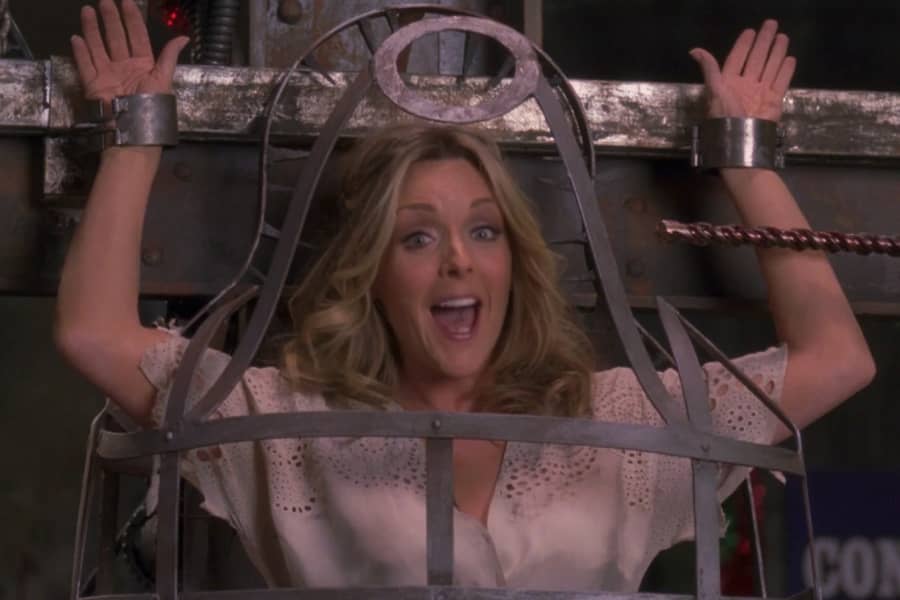 the woman in a cage (Maroney) looking very happy