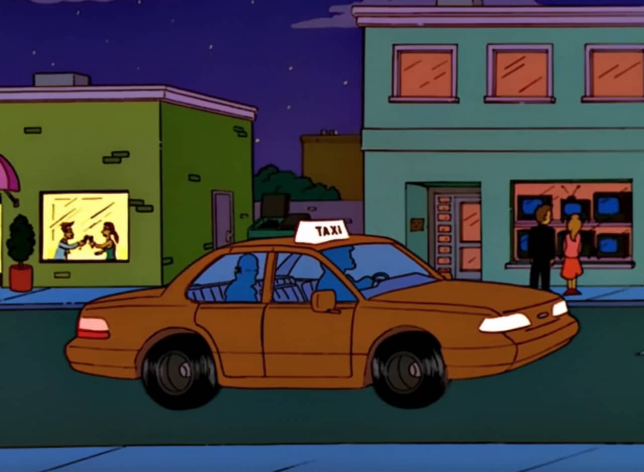taxi driving down the road