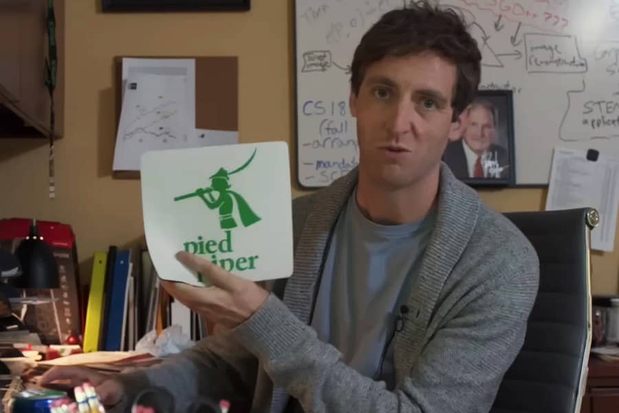 Richard Hendricks holding up a Pied Piper mouse pad