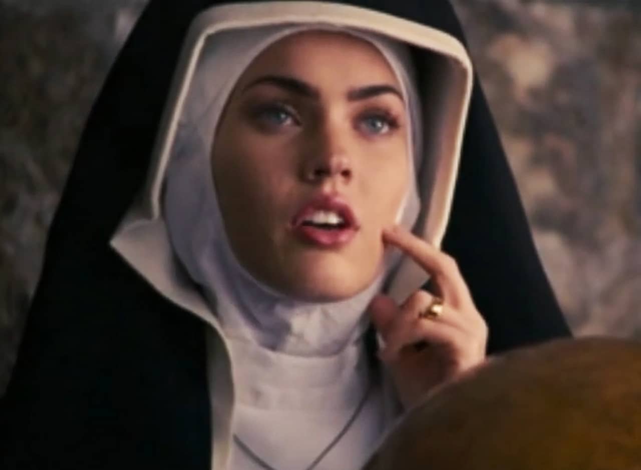 Sophie Maes, a young beautiful white woman, as Teresa dressed in a nun’s habit