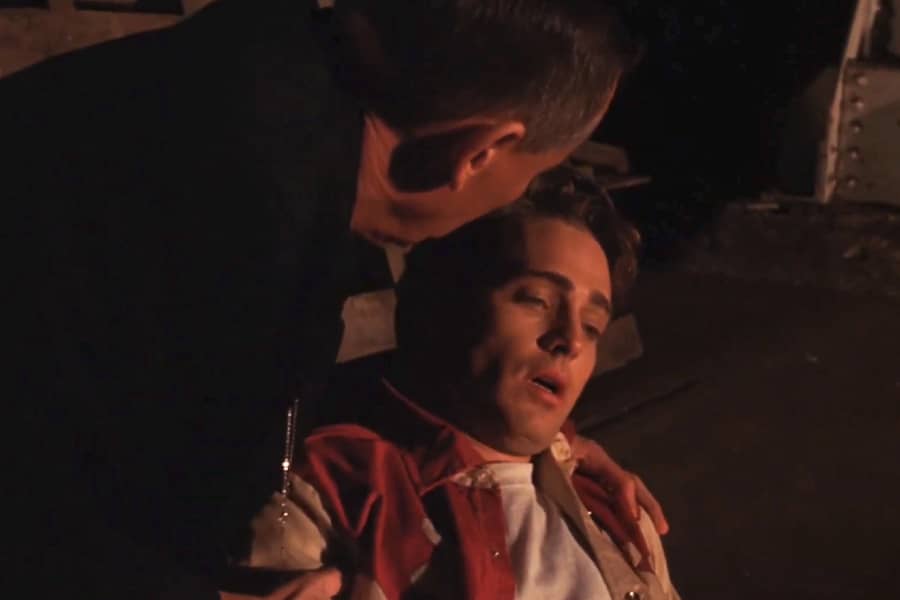 Johnny has been stabbed, lowered to the ground by Father Bryson