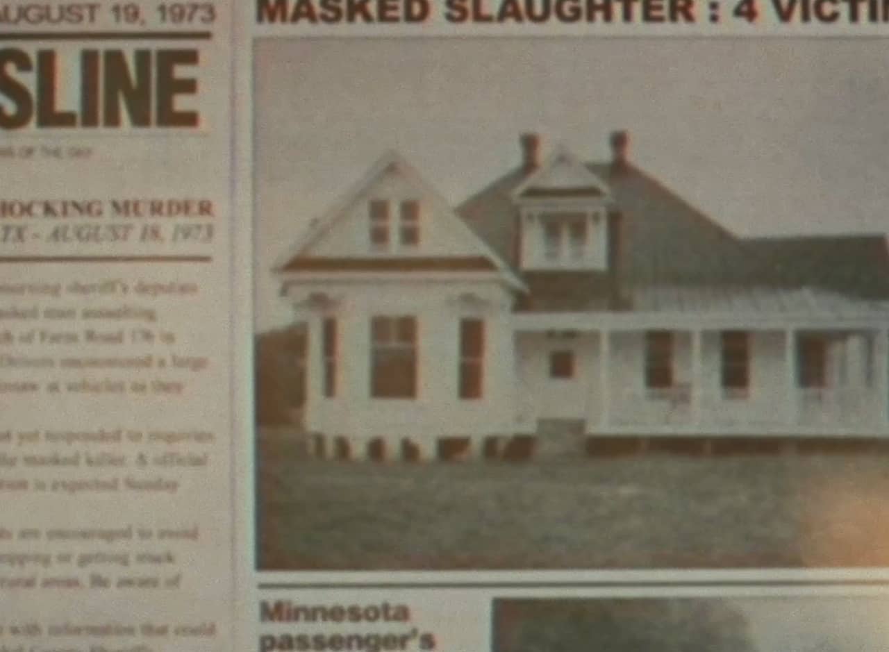 newspaper story about the murders with a photo of a house