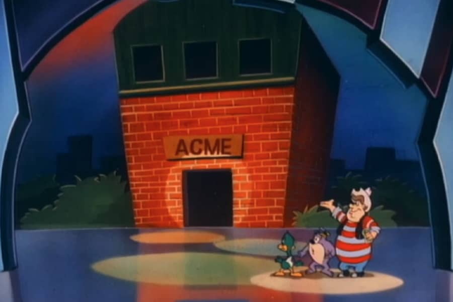 Pitfalls Dave with contestants by an ACME building