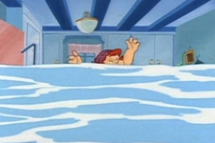 a woman flailing in a flooded kitchen