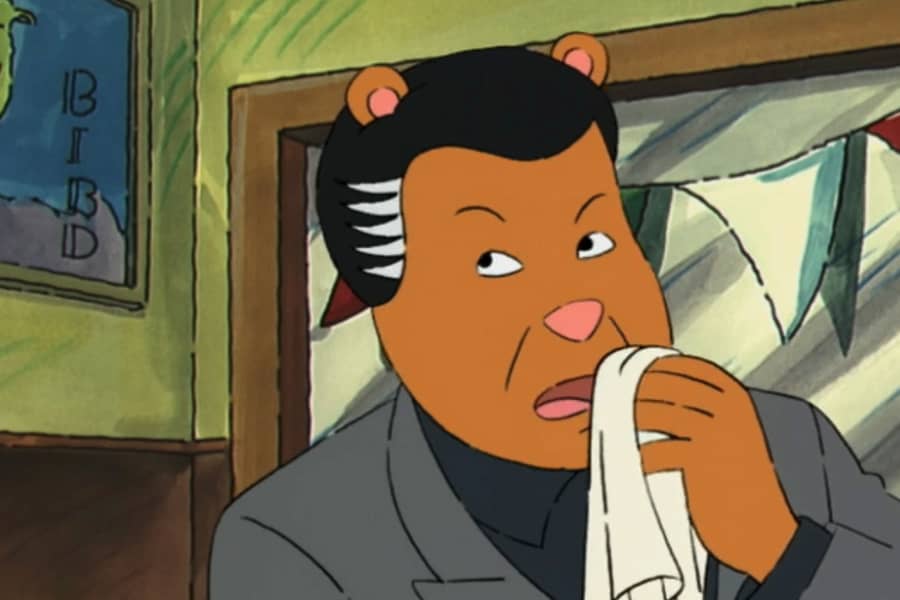 closeup of gangster with slicked back hair, cleaning his mouth with a napkin