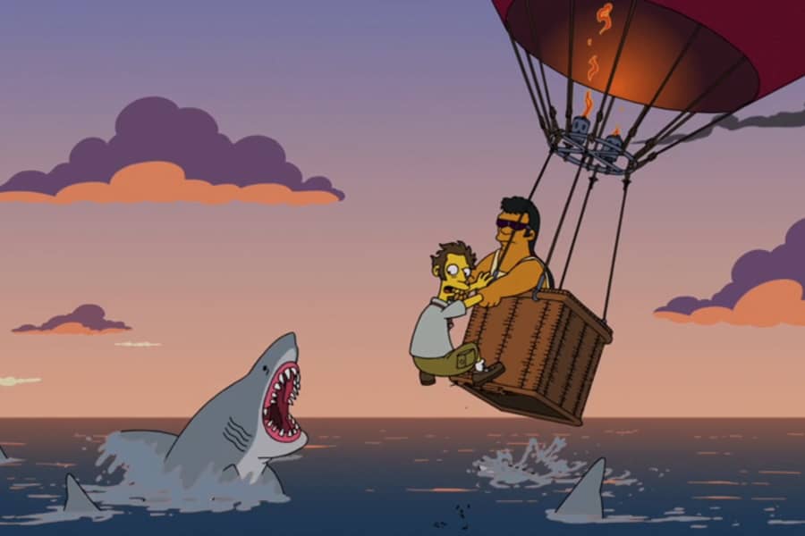 man being pulled into a low flying hot air balloon as sharks jump at him