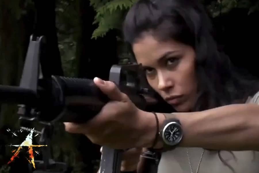 young Black female Marine aiming a gun