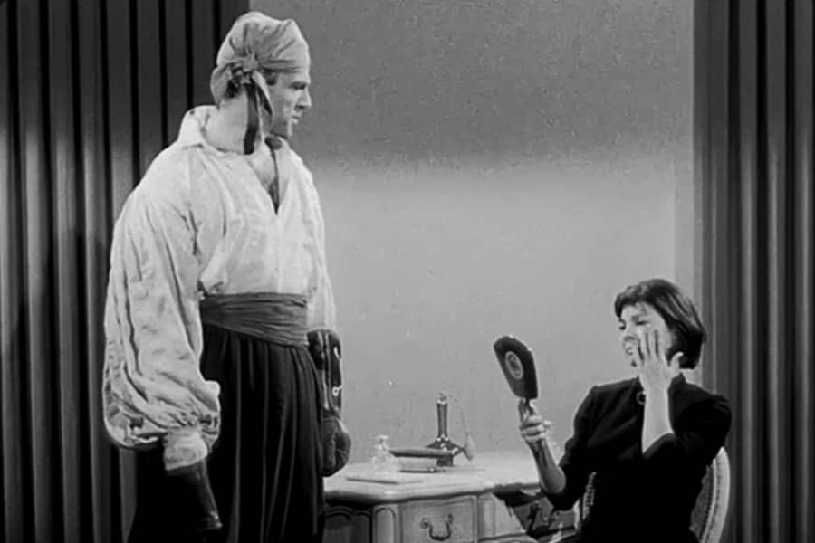 pirate visiting a woman who is looking into a hand mirror