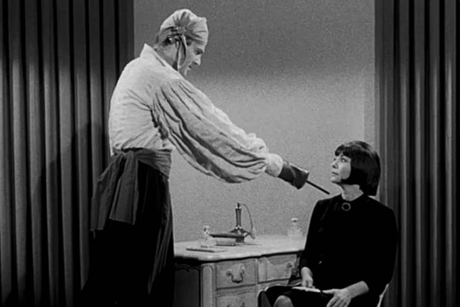 pirate touches the woman with his hook hand and she has a new haircut and a face full of makeup