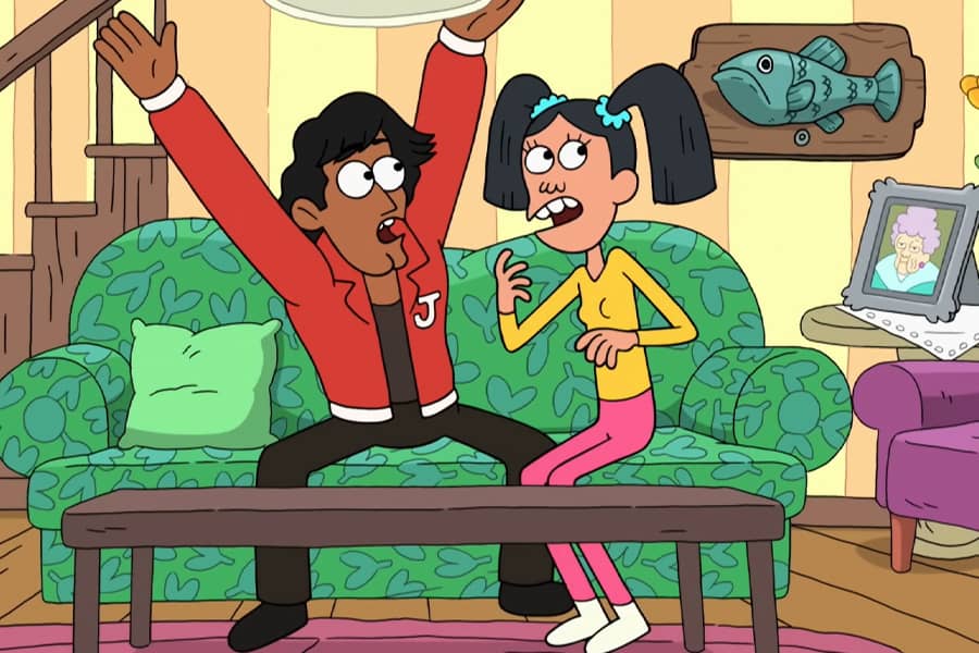 Poe and her boyfriend on the couch looking startled by the fish on the wall