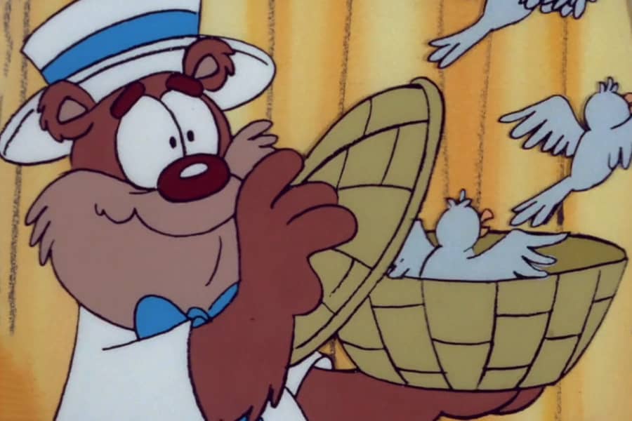 a Buddy Bear letting birds fly out of a woven basket