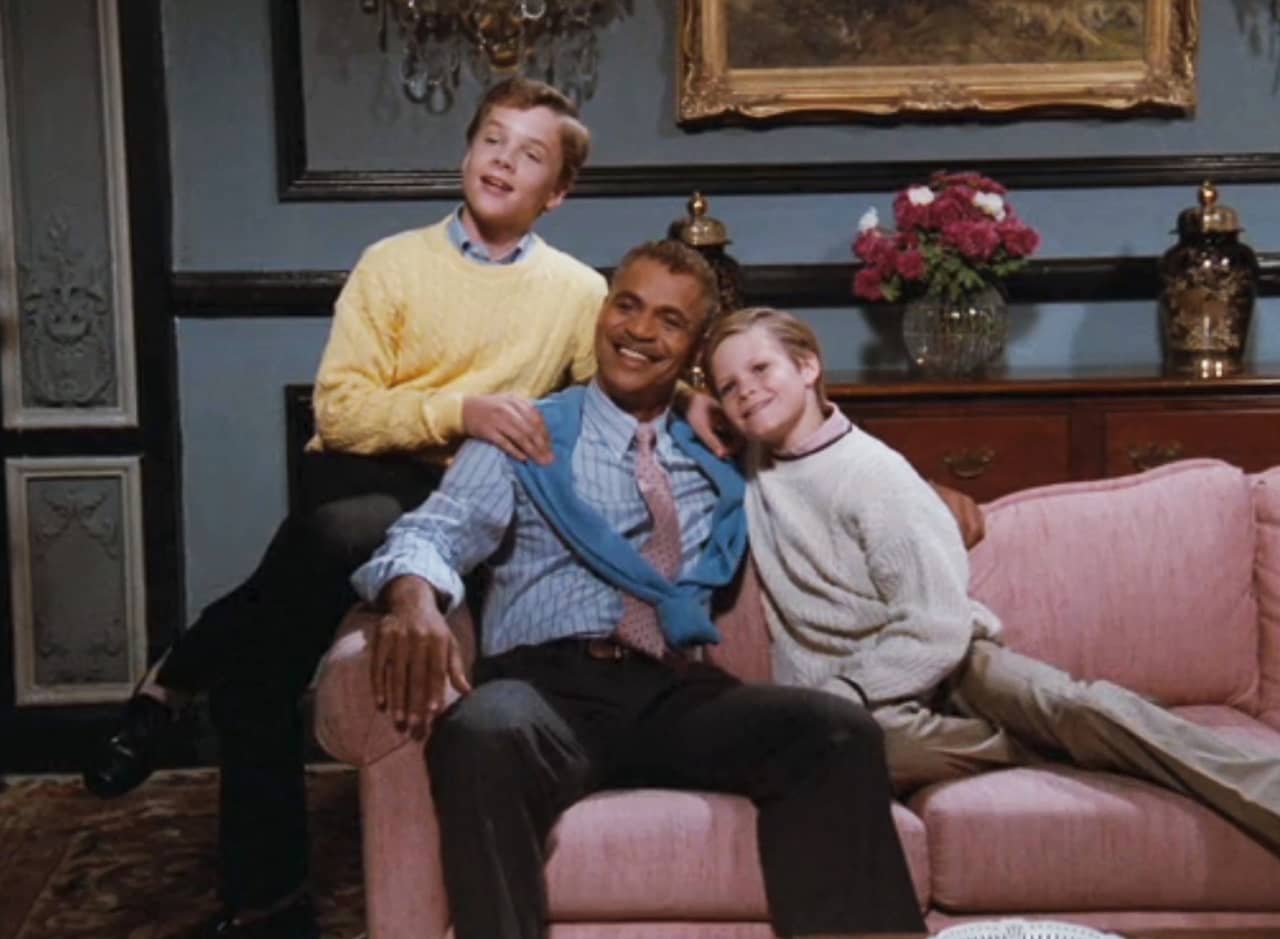 Buddy Goodrich, a black dad, with two white boy children, all wearing sweaters