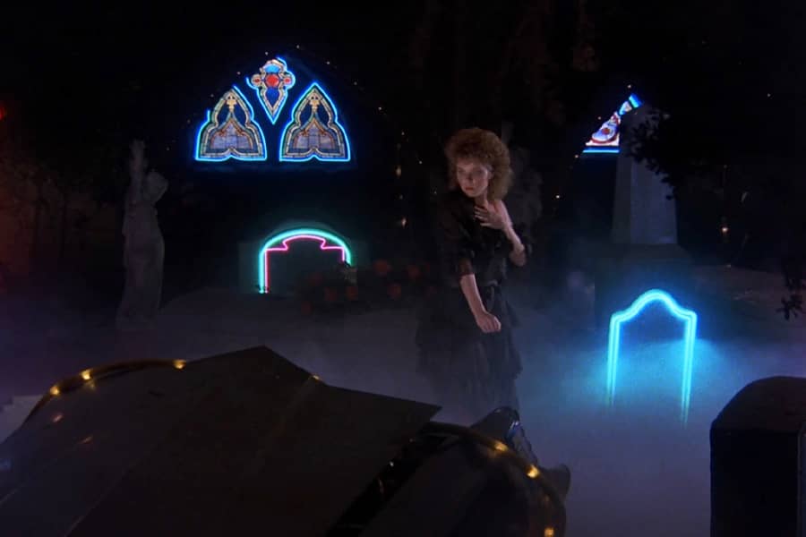 a woman in a neon graveyard