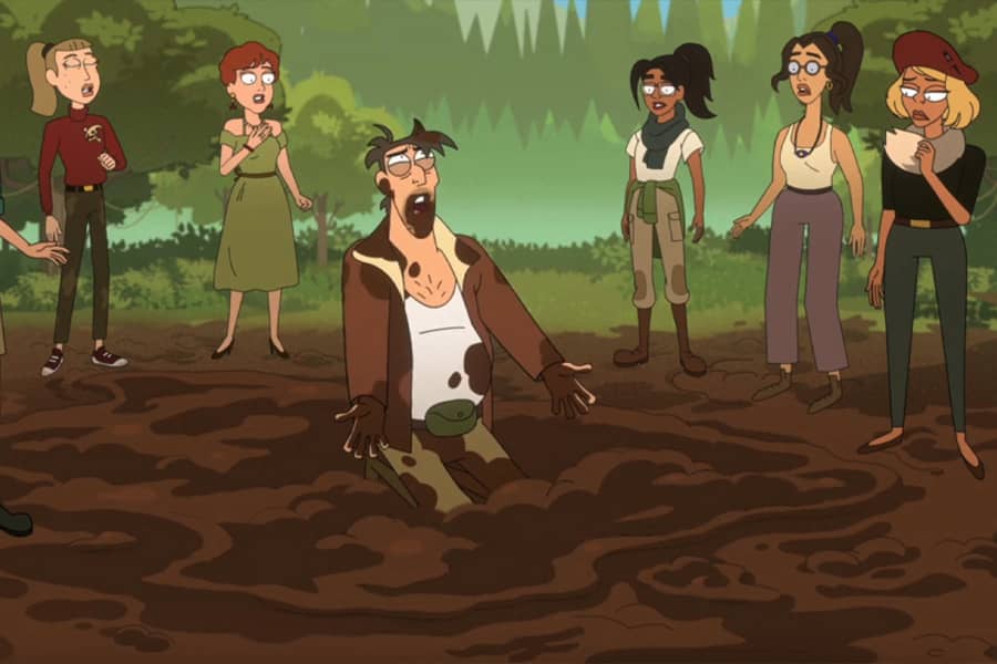 Rip Digman kneeling in and covered in mud as women stand around him