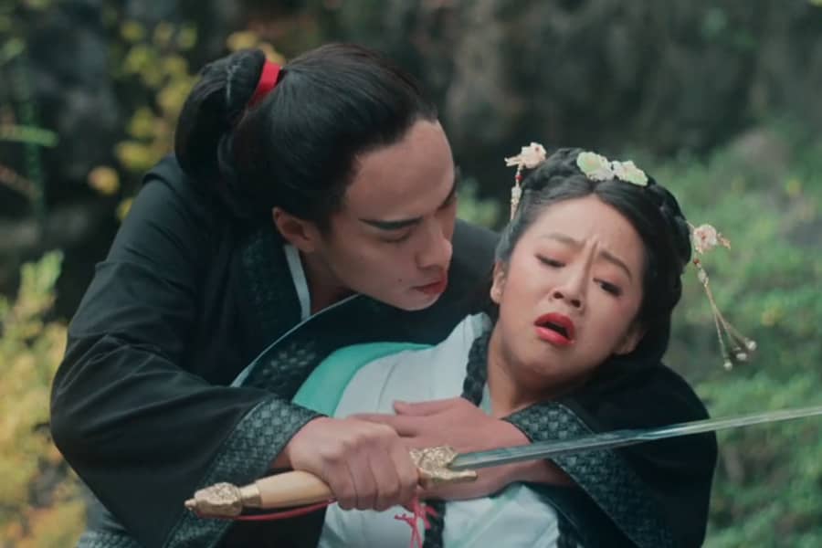 man holds sword to Chunhwa’s neck