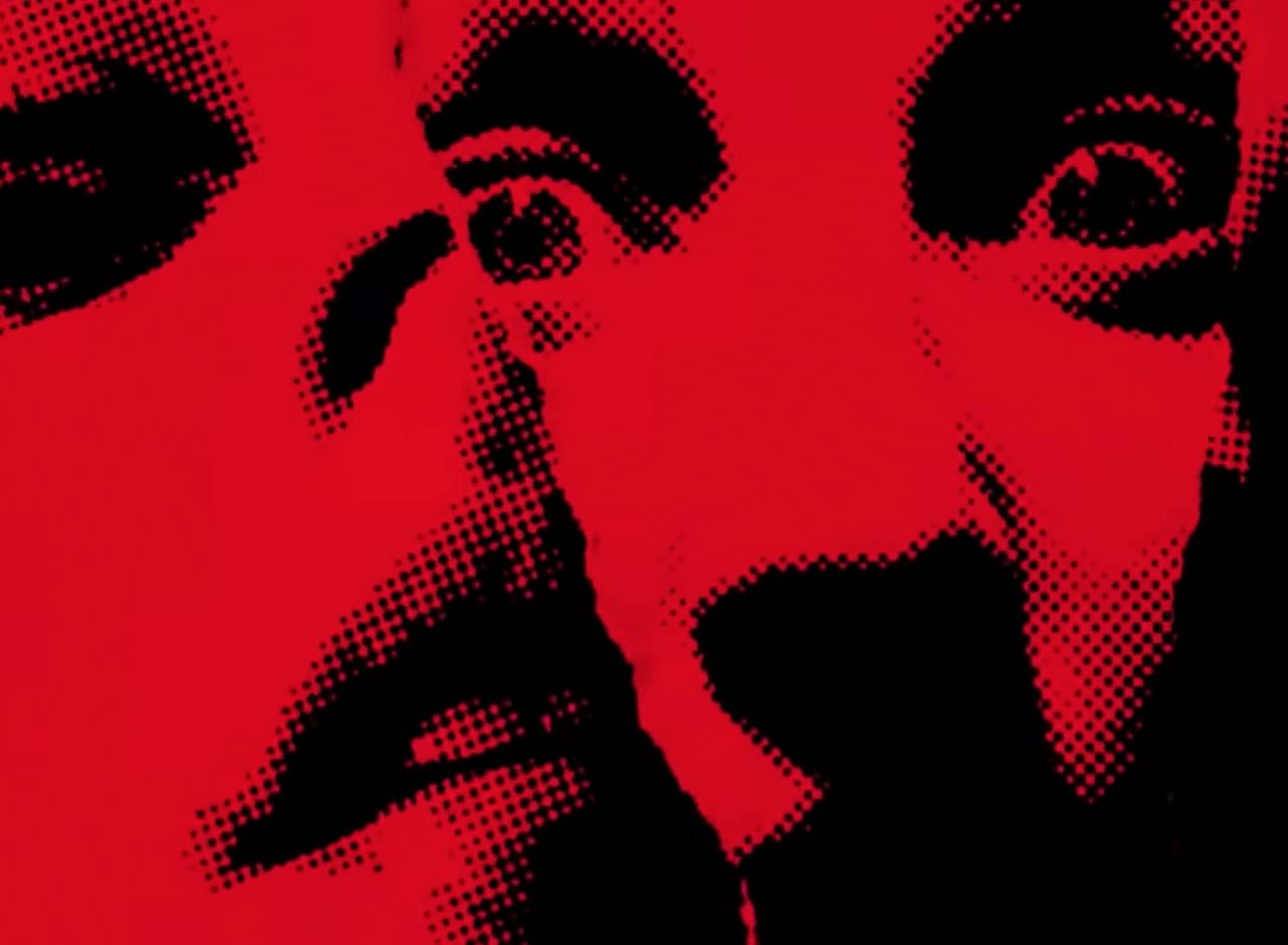 a graphic red and black halftone image of a scared woman’s face