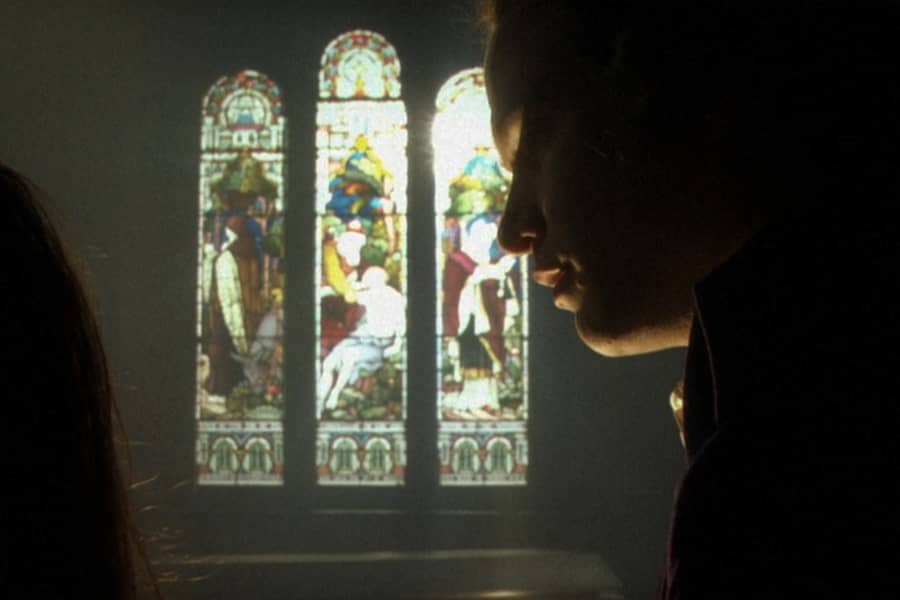 Roderick against colorful stained glass windows