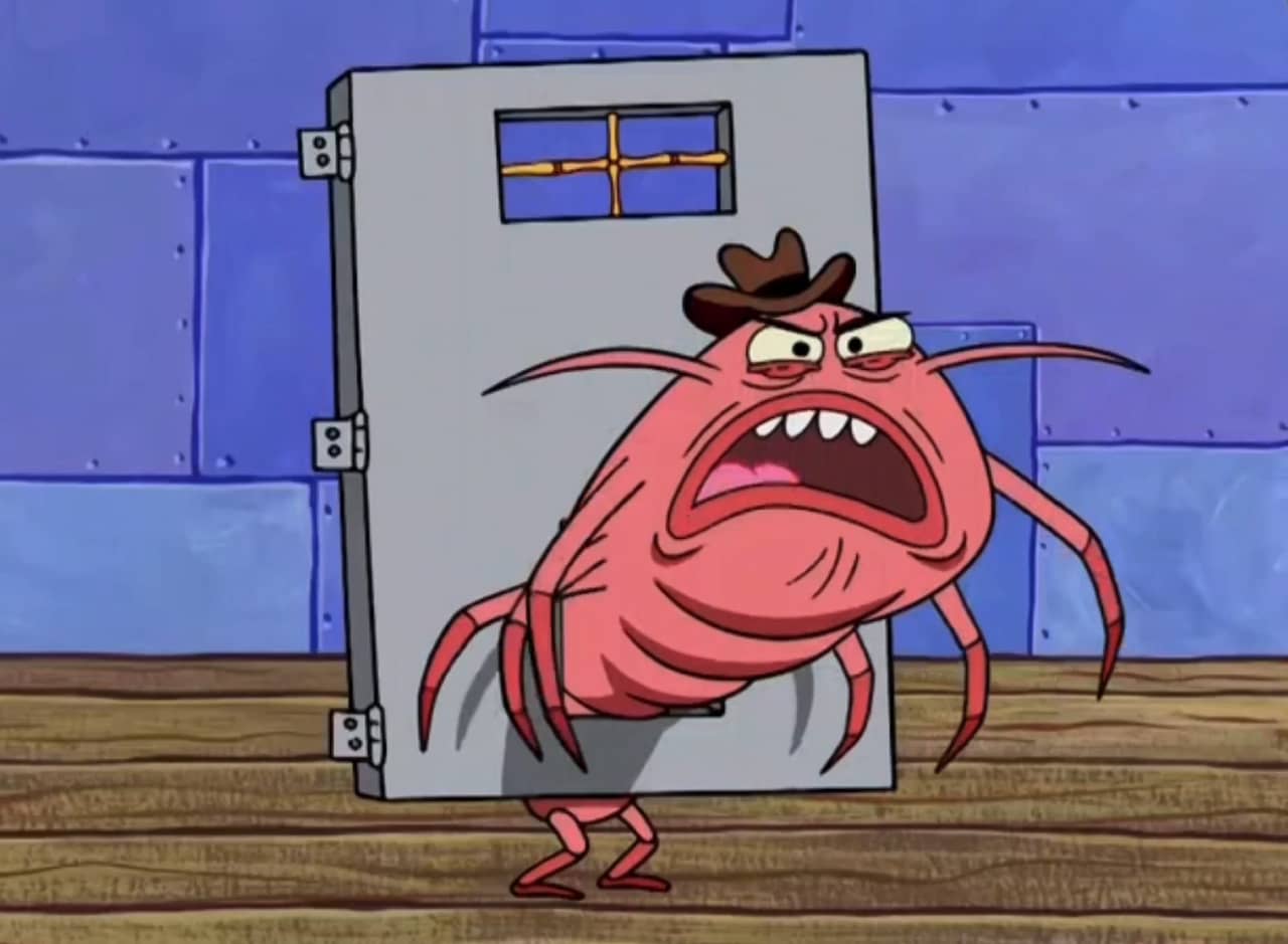 a giant isopod wearing a hat stuck in a pet door of a large door that’s off its hinges